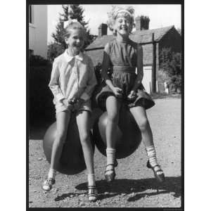  Two Little Girls Bouncing Gleefully on Their Spacehoppers 