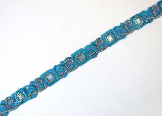 are turquoise tambour embroidery chain stitch done with a hook in blue 